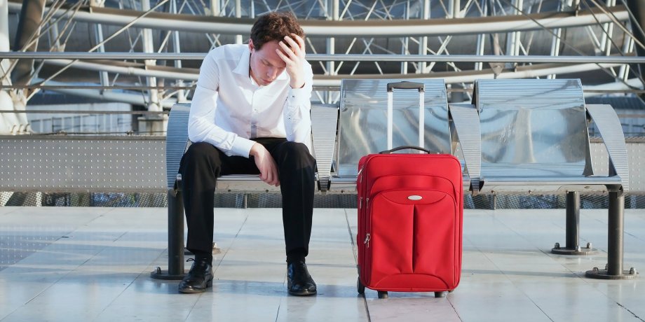 man-airport-suitcase-bench-upset.CDN5c127b40@2x